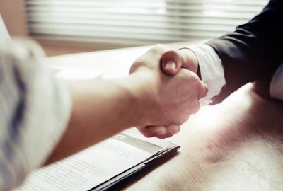 close up hand of two business people shaking hands after successful job interview in modern meeting room at office, home loan contract, partnership, teamwork and business contract concept close up hand of two business people shaking hands after successful job interview in modern meeting room at office, home loan contract, partnership, teamwork and business contract concept